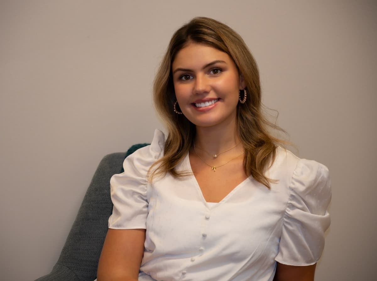 Kathryn Price seated in her Uptown Dallas therapy office
